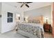 Main bedroom with floral bedding and ceiling fan at 1950 Marlington Way, Clearwater, FL 33763