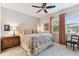 Main bedroom with floral bedding and ceiling fan at 1950 Marlington Way, Clearwater, FL 33763