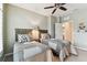 Bedroom with two twin beds, ceiling fan, and adjacent bathroom access at 1950 Marlington Way, Clearwater, FL 33763