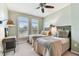 Bedroom with two twin beds, ceiling fan, and a calm color scheme at 1950 Marlington Way, Clearwater, FL 33763