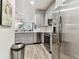 Modern kitchen with stainless steel appliances and white cabinets at 1950 Marlington Way, Clearwater, FL 33763