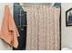 Shower stall with dark tile walls and a patterned shower curtain at 1950 Marlington Way, Clearwater, FL 33763