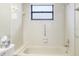 Bathroom with shower/tub combo and window at 217 Linger Ln, Sun City Center, FL 33573