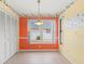 Bright dining area with an orange accent wall and a window overlooking the backyard at 217 Linger Ln, Sun City Center, FL 33573