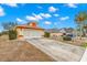 Front view of a single-story house with a two-car garage and driveway at 217 Linger Ln, Sun City Center, FL 33573