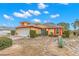 Landscaped yard and front entrance of a single story home at 217 Linger Ln, Sun City Center, FL 33573