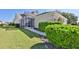 Landscaped backyard with lush greenery and screened patio at 217 Oceania Ct, Apollo Beach, FL 33572