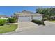 Two-car garage with driveway and nicely landscaped exterior at 217 Oceania Ct, Apollo Beach, FL 33572