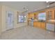 Kitchen with light wood cabinets, white appliances, and tile floor at 217 Oceania Ct, Apollo Beach, FL 33572