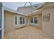 Back patio with flagstone flooring and access from interior at 217 Oceania Ct, Apollo Beach, FL 33572