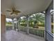 Spacious screened porch overlooking backyard with palm trees at 217 Oceania Ct, Apollo Beach, FL 33572