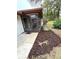 View of a screened porch with a door and landscaping at 2200 Shelly Dr # C, Palm Harbor, FL 34684