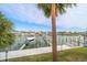 Private boat dock with two boats and palm trees at 224 Skiff Pt # 224, Clearwater Beach, FL 33767