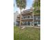 Three-story building exterior with balconies and landscaping at 224 Skiff Pt # 224, Clearwater Beach, FL 33767