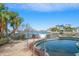 Community pool with palm trees and waterfront view at 224 Skiff Pt # 224, Clearwater Beach, FL 33767