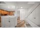 Modern white staircase with glass railing and wood flooring at 224 Skiff Pt # 224, Clearwater Beach, FL 33767