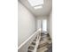 Modern white staircase and hallway with glass railing and wood flooring at 224 Skiff Pt # 224, Clearwater Beach, FL 33767