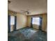 Bright bedroom with blue carpeting and window coverings at 2241 Greenwich Dr # 2241, Sun City Center, FL 33573