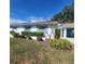 Front view of house with landscaping and a blue door at 2241 Greenwich Dr # 2241, Sun City Center, FL 33573