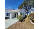 Front view of house with covered carport and landscaping at 2241 Greenwich Dr # 2241, Sun City Center, FL 33573