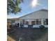 Rear view of the house showing a sunroom and landscaping at 2241 Greenwich Dr # 2241, Sun City Center, FL 33573