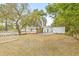 Large backyard with a white fence and mature trees at 2255 S Lagoon Cir, Clearwater, FL 33765