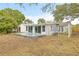 Large backyard with a wooden fence and gate at 2255 S Lagoon Cir, Clearwater, FL 33765