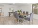 Light and airy dining area with wood table and chairs at 2255 S Lagoon Cir, Clearwater, FL 33765