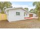 White house with new wood fence and landscaping at 2255 S Lagoon Cir, Clearwater, FL 33765