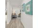 Bright hallway with wood-look floors and artwork at 2255 S Lagoon Cir, Clearwater, FL 33765