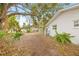 Side yard with a dirt path leading to the backyard at 2255 S Lagoon Cir, Clearwater, FL 33765