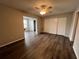 Large bedroom with double closets and gray laminate flooring at 2449 Columbia Dr # 55, Clearwater, FL 33763