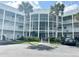 Condo building exterior with palm trees and parking at 2449 Columbia Dr # 55, Clearwater, FL 33763