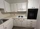 Updated kitchen with white cabinets, a gas cooktop, and built-in oven at 2449 Columbia Dr # 55, Clearwater, FL 33763