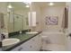 Clean bathroom with double sinks, bathtub, and shower at 2577 Estancia Blvd, Clearwater, FL 33761