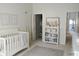 Bright Bedroom with white crib, surfboard decor, and shelving for storage at 2577 Estancia Blvd, Clearwater, FL 33761