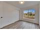 Bedroom with large window, double closet, and wood-look floors at 2901 Forestwood Dr, Seffner, FL 33584