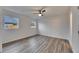 Bright bedroom featuring wood-look floors and ceiling fan at 2901 Forestwood Dr, Seffner, FL 33584