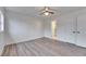 Bedroom with ceiling fan, wood floors, and bathroom access at 2901 Forestwood Dr, Seffner, FL 33584