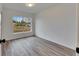 Bright bedroom with wood-look flooring and a large window at 2901 Forestwood Dr, Seffner, FL 33584