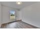 Well-lit bedroom with wood-look floors and exterior view at 2901 Forestwood Dr, Seffner, FL 33584