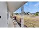 Side view of the house showcasing a covered porch and neighborhood view at 2901 Forestwood Dr, Seffner, FL 33584