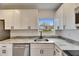 Modern kitchen with white shaker cabinets, granite countertops, and stainless steel appliances at 2901 Forestwood Dr, Seffner, FL 33584