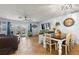 Casual dining area with a farmhouse table and chairs, adjacent to the living room at 29836 69Th N Way, Clearwater, FL 33761