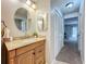 Bright bathroom with vanity, mirror, and view to bedroom at 3005 Enisglen Dr, Palm Harbor, FL 34683