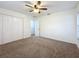 Bright bedroom featuring ceiling fan and ample closet space at 3005 Enisglen Dr, Palm Harbor, FL 34683