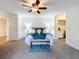 Bright bedroom with ceiling fan, carpet, and ensuite bathroom at 3005 Enisglen Dr, Palm Harbor, FL 34683