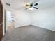 Bedroom with carpet, ceiling fan and view to living room at 3005 Enisglen Dr, Palm Harbor, FL 34683