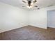 Spacious bedroom with ceiling fan and carpeted floor at 3005 Enisglen Dr, Palm Harbor, FL 34683