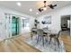 Dining area with pool view, modern table and chairs, and ceiling fan at 3005 Enisglen Dr, Palm Harbor, FL 34683